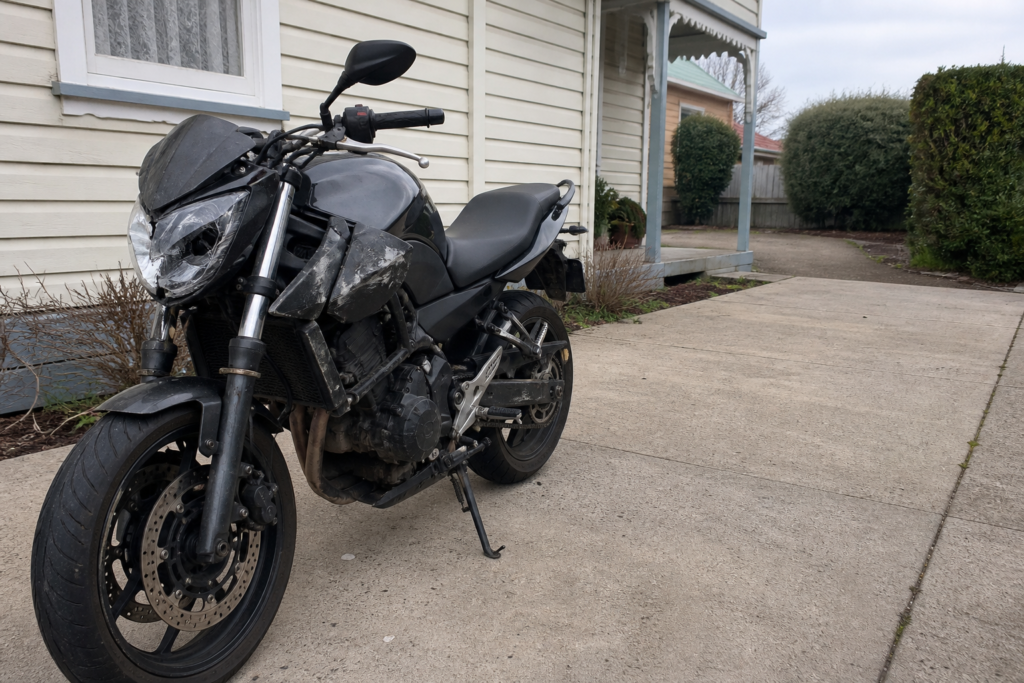 Crash-damaged motorcycle in a Ballarat driveway ready for assessment